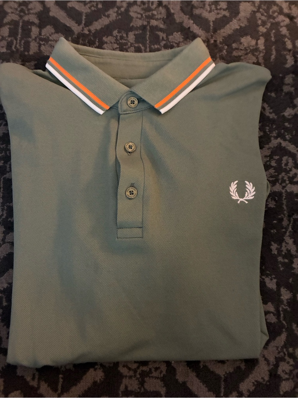 Fred Perry Men’s Olive green polo with orange and white twin piping.